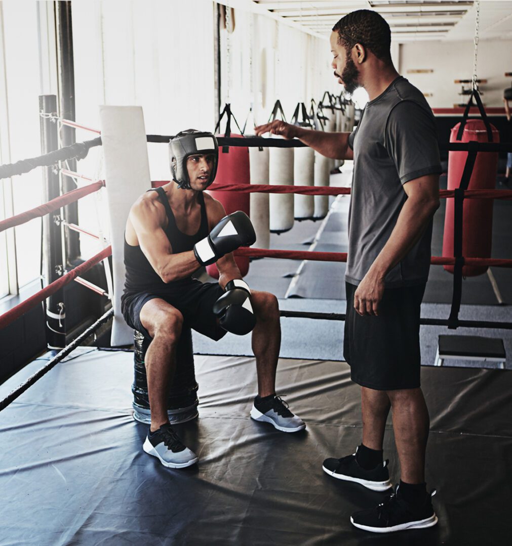 Trainer advising boxer during practice